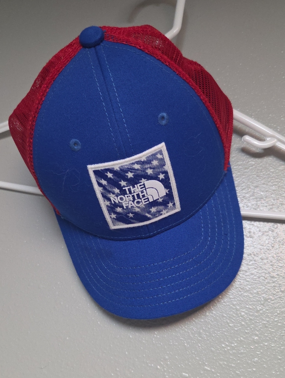 The North Face Kids Royal Blue and Red Mesh Trucker Hat